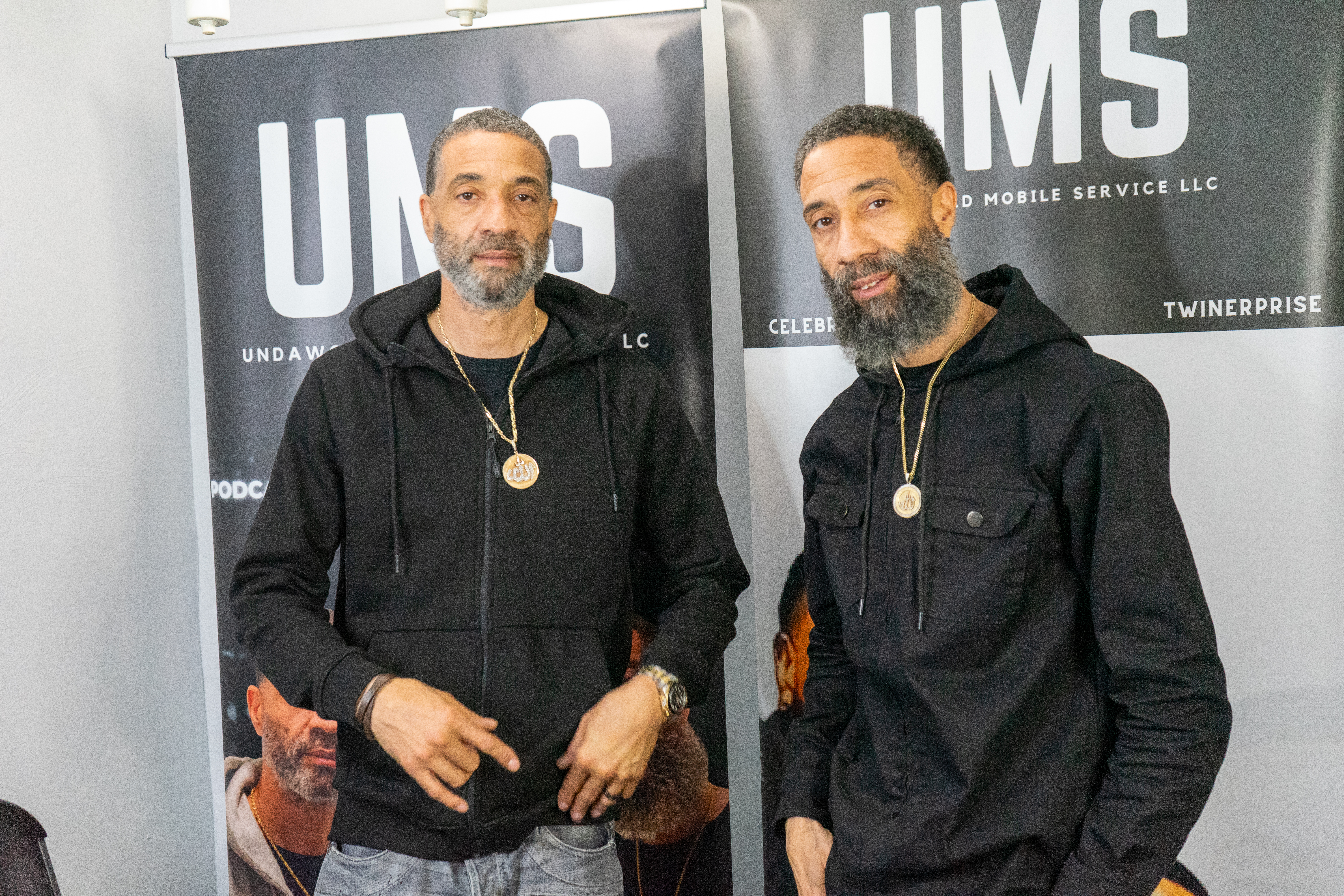 Photo of twins in black hoodies. 